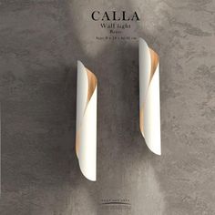 two white and gold wall lights against a gray background with the words calla on it