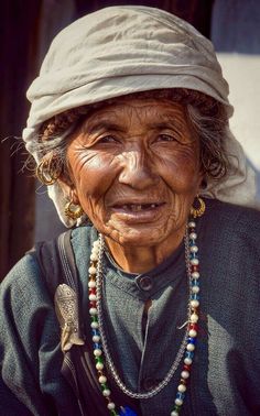 an old woman with beads on her neck