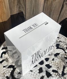 a white box with the words thank you on it sitting on top of a table