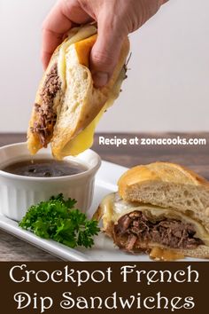 a person is dipping sauce into a sandwich on a white plate with the words crockpot french dip sandwiches dinner for two