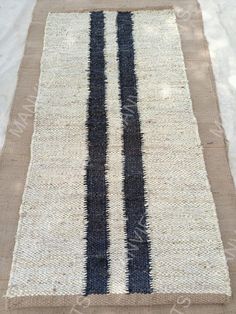 a black and white striped rug on the ground