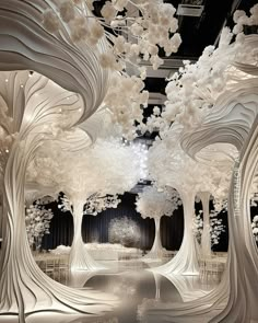 an art installation with white trees and flowers