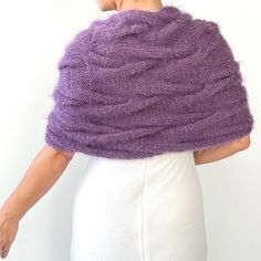 a woman wearing a purple knitted shawl