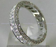 an image of a wedding ring with diamonds on the inside and outside, set in white gold