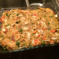 a casserole dish with shrimp and vegetables in it