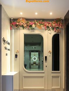 an entrance to a building decorated with flowers