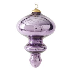 a purple glass ornament hanging on a white wall