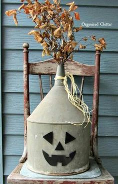 an old chair with a potted plant in the shape of a jack - o'- lantern