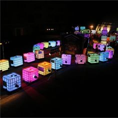 many glowing cubes are on the ground at night