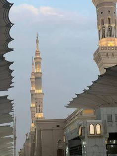 a tall white building with a clock tower in the background