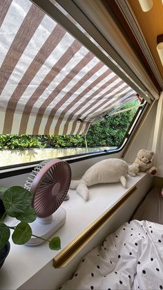 there are stuffed animals on the windowsills in this camper's bed