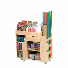 a wooden storage cart filled with lots of crafting supplies and pencils on wheels