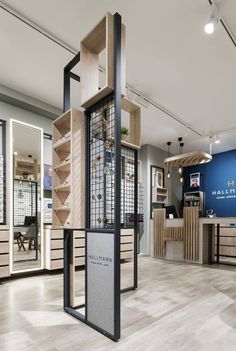 the inside of a retail store with wooden shelves and shelving units in it's center