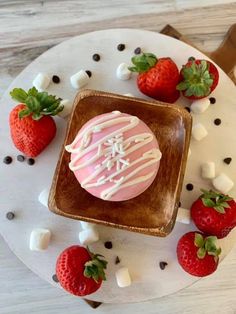 a cake with white frosting and strawberries on a plate