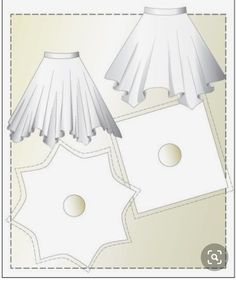 two white lampshades sitting next to each other on top of a piece of paper