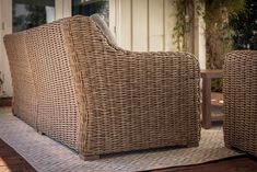 two wicker chairs sitting on top of a wooden floor