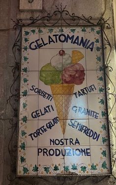 a sign on the side of a building that says gelato maniana and ice cream