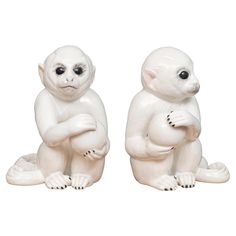 two white ceramic animals sitting next to each other