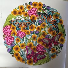 a drawing of flowers and butterflies in a circle