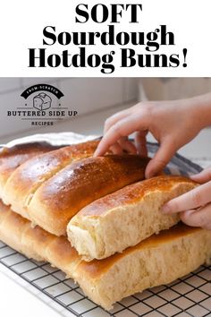 someone is touching some bread on top of a cooling rack with the words, soft sourdough hotdog buns buttered side up