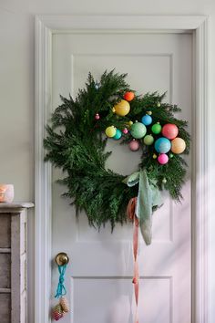 a christmas wreath hanging on the front door