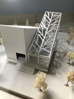 a model of a building with trees surrounding it