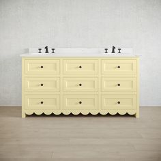 a bathroom with two sinks and a yellow cabinet