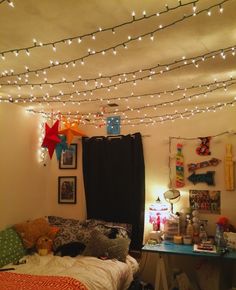 a bedroom with lights strung from the ceiling