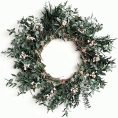 a wreath with white flowers and green leaves