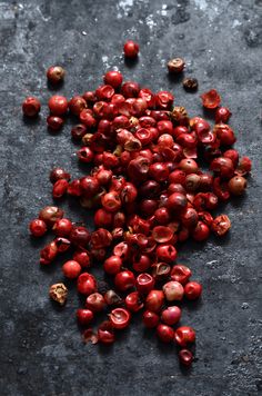 cranberry seeds are scattered on a black surface