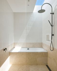 A generous bathroom featuring a large skylight, filling the room with natural light was created with our first floor extension. Neutral stone palette stone with warmer tones paired with a timber veneer contrasted with a bright white textured tile to fit the light bright and neutral brief. Bathroom Skylight, Stone Palette, Large Skylight, Room With Natural Light, Textured Tile, Neutral Stone, Timber Veneer, Connected Home, Light Bright