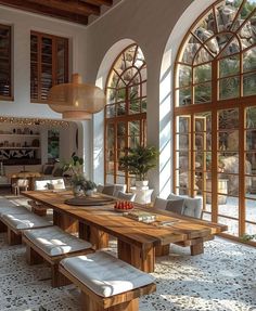 a large dining room with lots of windows and wooden tables in the middle of it