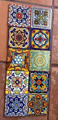 colorful tiles are arranged on the side of a wall