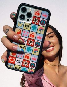 a woman holding up her phone case with peace signs on it