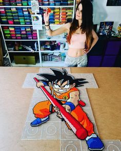 a woman standing in front of a table with a cut out of a cartoon character on it