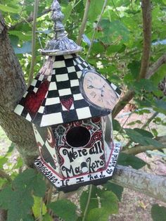 a bird house hanging from a tree branch