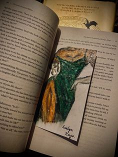 an open book with a drawing of a woman's dress on top of it