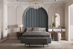 a bedroom with a large bed and chandelier