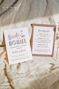 the wedding stationery is laid out on the bed