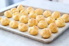 a baking tray filled with rolls on top of a counter