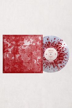 a red and white record sitting on top of a table