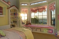 a child's bedroom with pink and yellow decor, including a large window overlooking the city