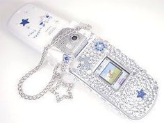 a white cell phone with blue stars on it's side and a chain attached to it