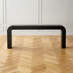 a black table sitting on top of a hard wood floor