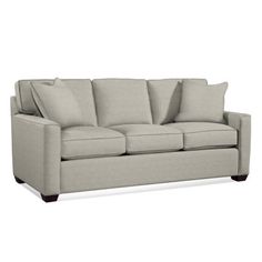 an image of a couch with pillows on the top and bottom half, in light gray linen