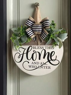 a door hanger with a bow on it that says, bless this home and all who enter