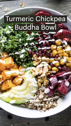 a white bowl filled with different types of food on top of a wooden table and text overlay that reads turmric chickpea buddha bowl