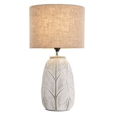 a white table lamp with a beige shade