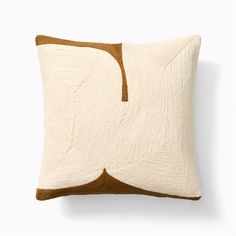 a white and brown pillow sitting on top of a table