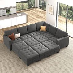 a large gray couch sitting on top of a wooden floor